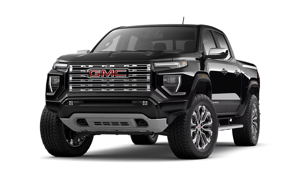 A black 2026 GMC Canyon Denali with red GMC badging on the grille
