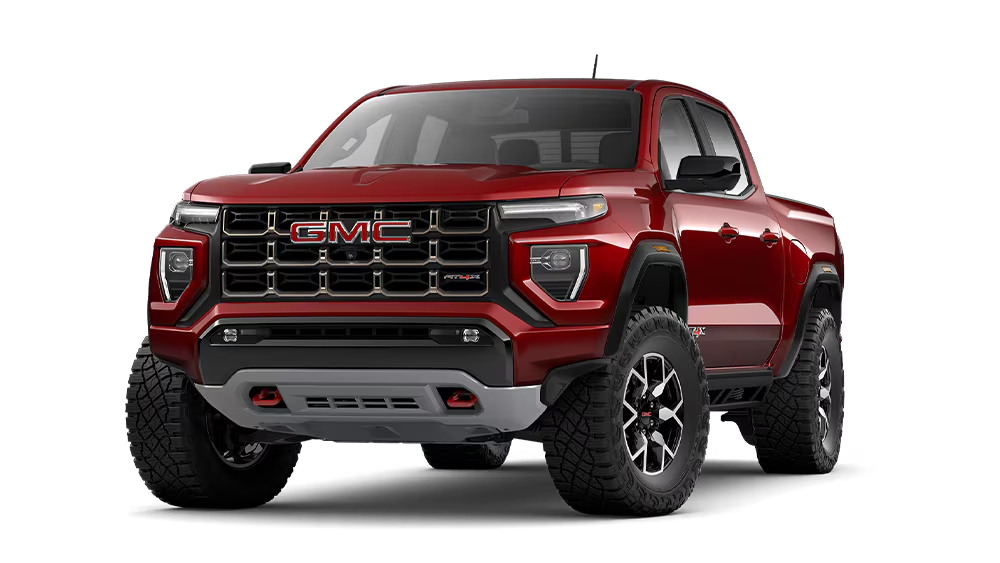 A red 2026 GMC Canyon AT4X with red badging on the grille