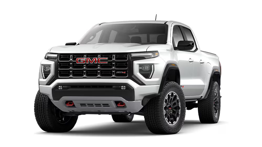 A white 2026 GMC Canyon AT4 with red GMC badging on the grille