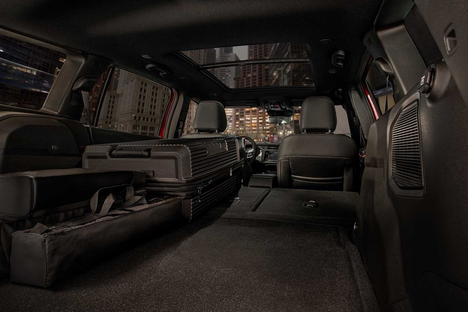 the roomy interior of the 2026 Jeep Cherokee with the rear seats folded down to accommodate more cargo