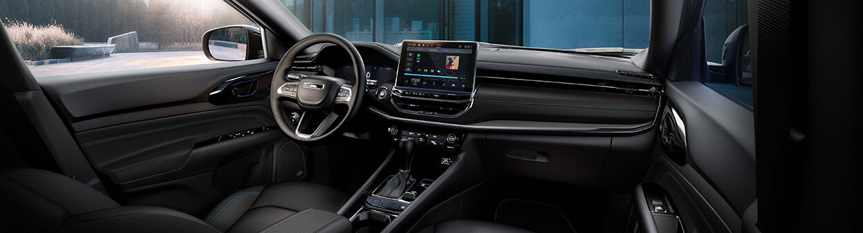 The dashboard of a 2026 Jeep Compass, featuring its steering wheel and 10.1-inch colour touchscreen
