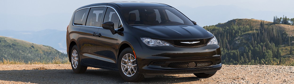 A black 2026 Chrysler Grand Caravan is parked on the off-road on top of a cliff