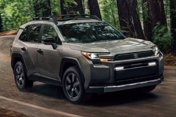 2026 Toyota RAV4 vehicle comparisons at Laplante Chrysler Dodge Jeep Ram in Embrun, ON. A brown 2026 Toyota RAV4 drives along a forest road.