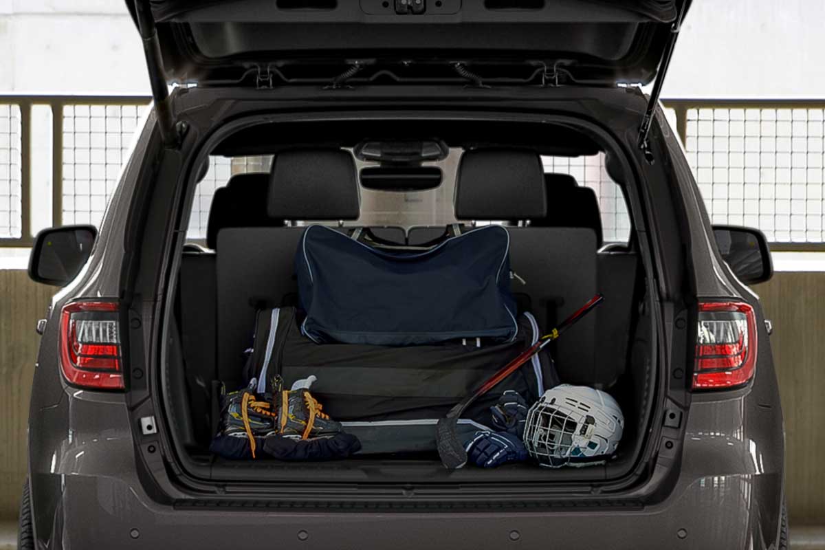 The open trunk of a 2026 Dodge Durango is pilled with gear. The second row seats are up.