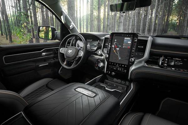 The interior of the 2026 Ram Tungsten with black leather seats and a vertical digital dashboard display