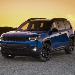 2026 Jeep Compass blue compact SUV parked on a gravel overlook at sunset with hills in the background, featured by Leavens Chrysler Dodge Jeep RAM London Ontario.