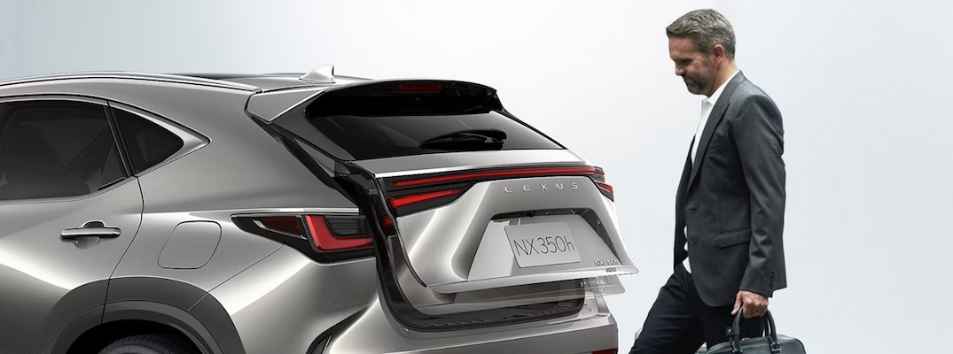A man opens the power liftgate of the 2026 Lexus NX.