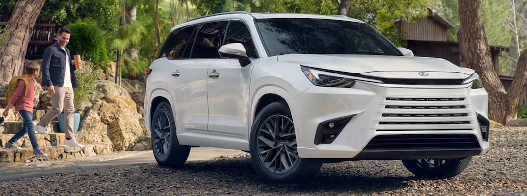 A 2026 Lexus TX in wind chill pearl with people approaching.