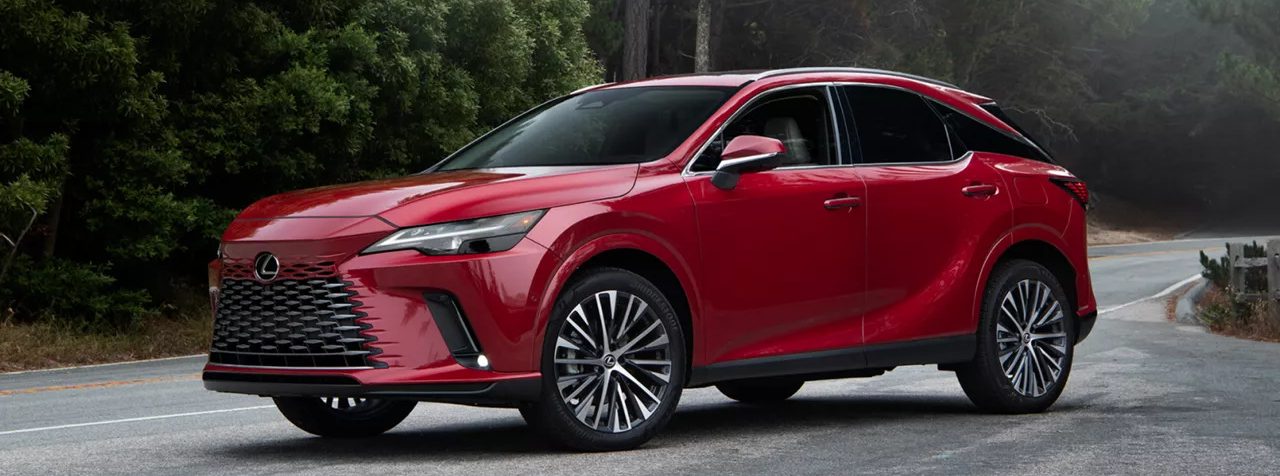 2026 Lexus 350h parked on a winding road surrounded by trees