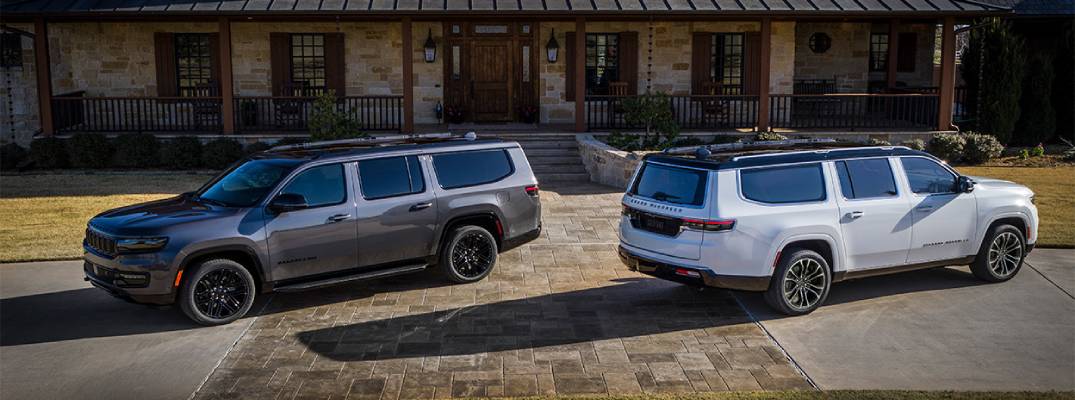 Two Jeep Grand Wagoneers parked next to each other.