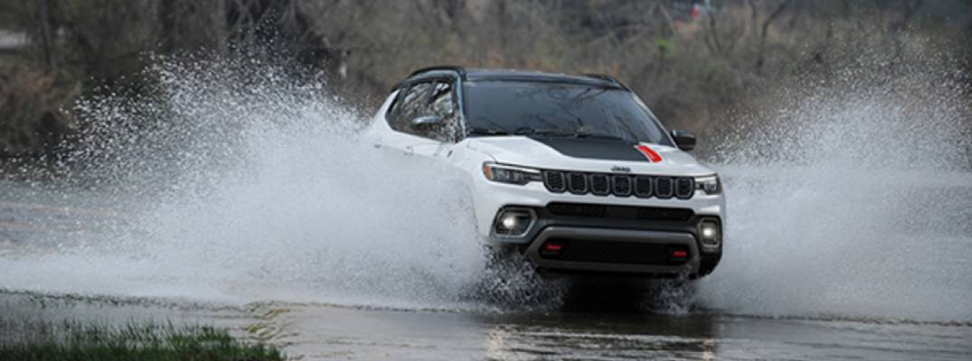 2026 Jeep Compass Trailhawk driving through wet terrain