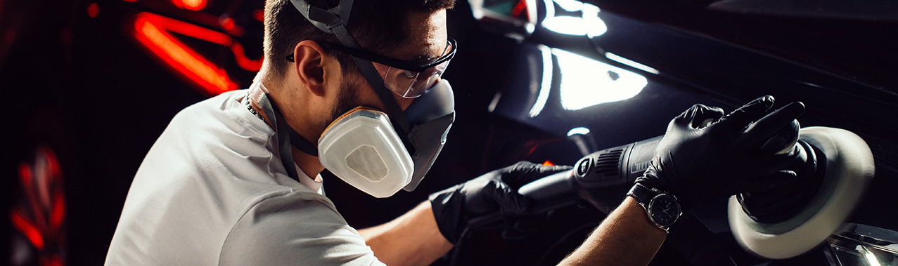 Car polish wax. worker hands holding a polisher and polish car