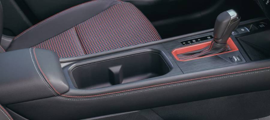 The 2026 Nissan Kicks's front seats and gearstick with red accents