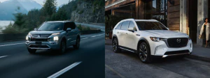 2026 Mitsubishi Outlander PHEV driving down the highway and the 2026 Mazda CX-90 PHEV parked by the sidewalk