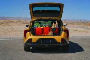 The open trunk of a 2026 Kia K4 Hatchback filled with bags and gear. New 2026 Kia K4 Hatchback & 2026 Kia K4 Sedan vehicle comparison guide at Miramichi Kia in Miramichi, NB