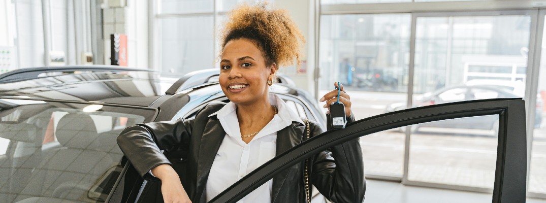 A stock photo of a person buying a car.