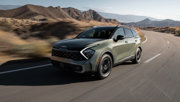 Front side view of Kia Sportage driving on road