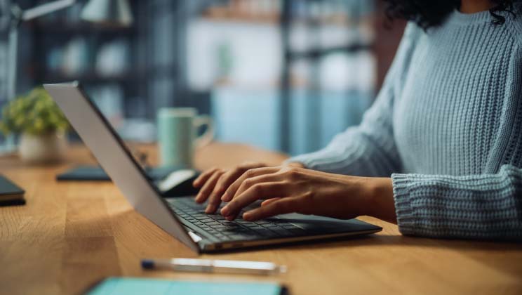 Person using laptop on desk