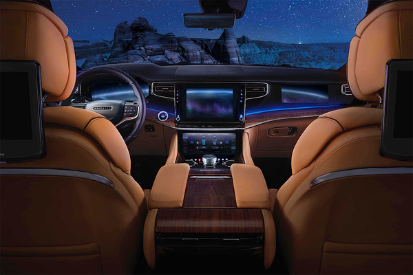 The front seats and infotainment centre of the 2026 Jeep Grand Wagoneer in front of a night sky