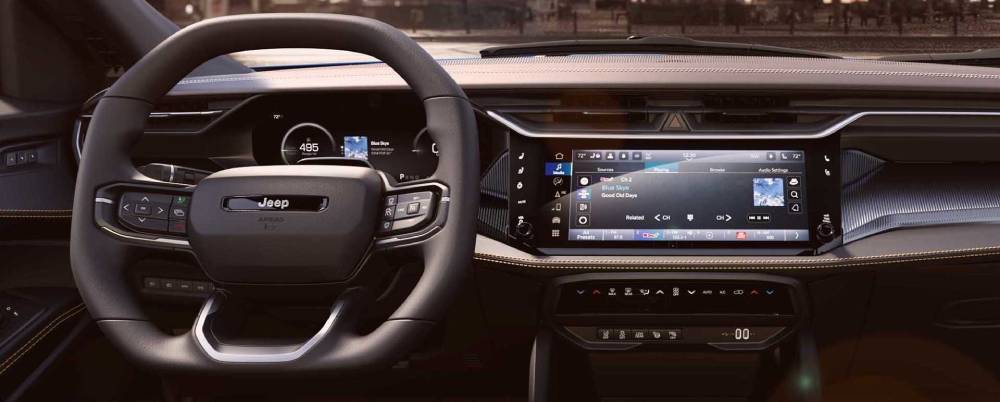 The dashboard screen and steering wheel of the 2026 Jeep Cherokee. New 2026 Jeep Cherokee for sale at Orangeville Chrysler Dodge Jeep Ram