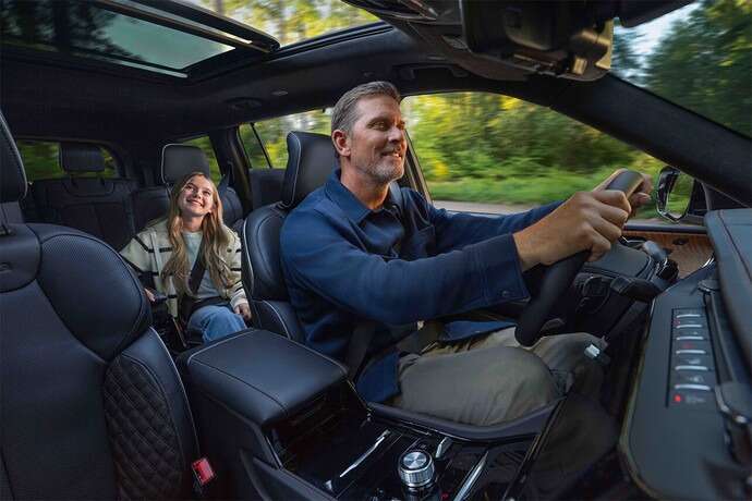 a father and child inside the 2026 jeep grand cherokee. 2026 jeep grand cherokee design at orangeville chrysler dodge jeep ram in orangeville, on