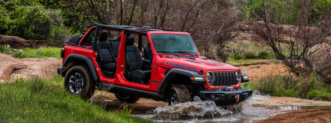 2025 Jeep Wrangler 4xe driving through a stream