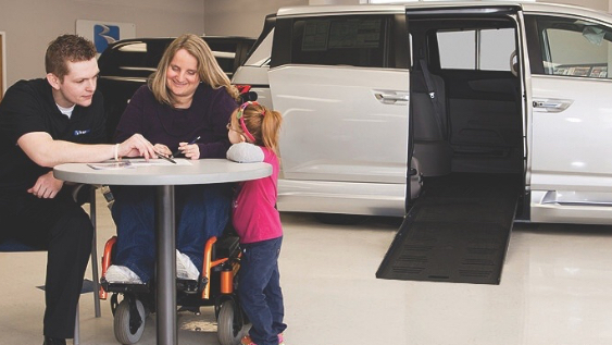 family_with_accessibility_needs_at_dealership_looking_at_vehicles_in_fully_accessible_facility (1)