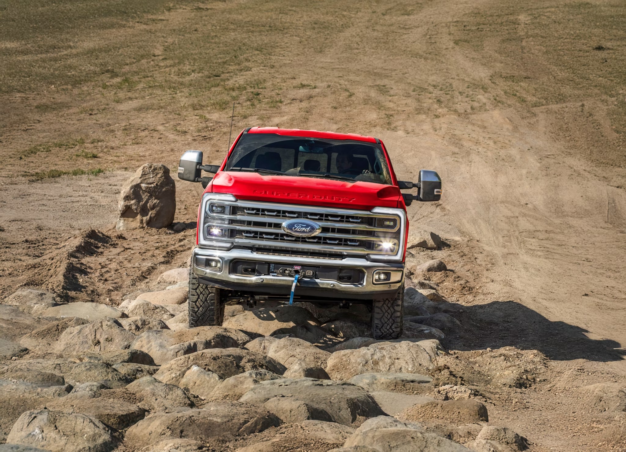 2026 Ford Super Duty driving over rocky terrain