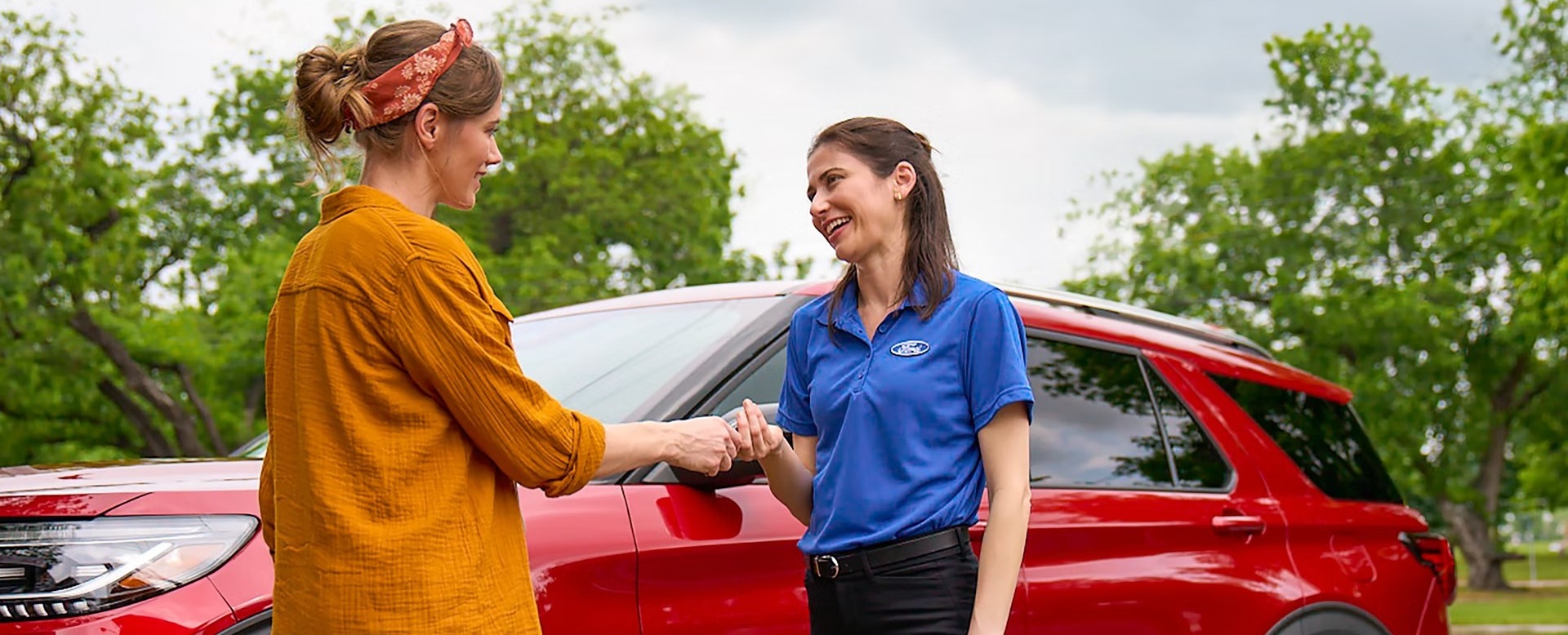 Unknown person handing Ford employee unknown object