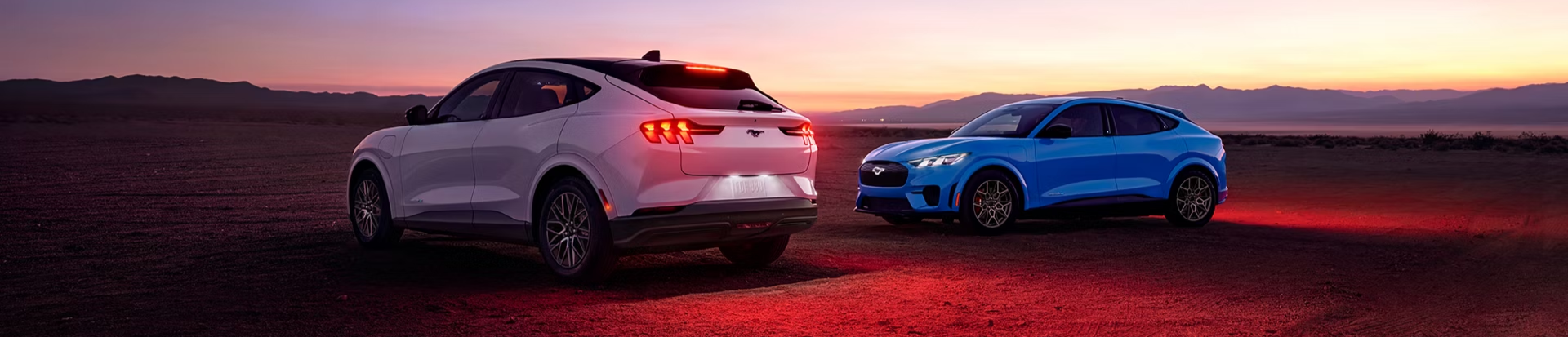 Ford SUVs parked outdoors with sun setting in the background