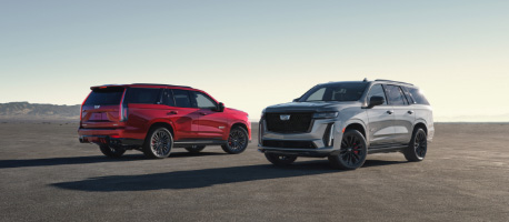 red_and_silver_escalade_side_by_side_in_open_space.jpg