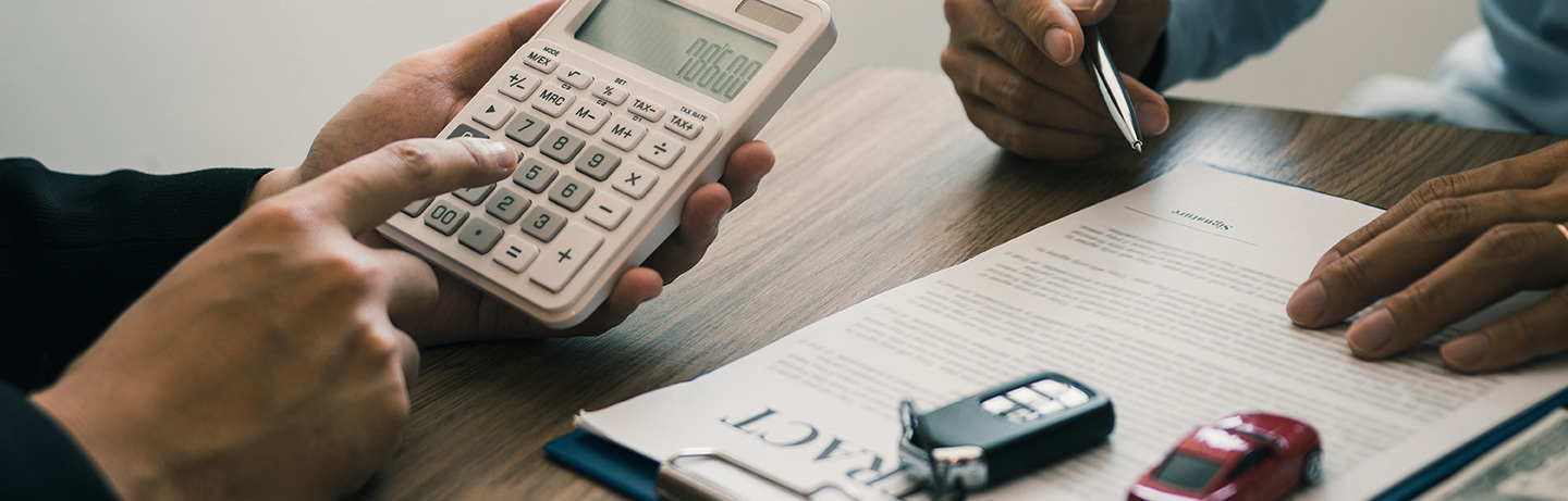 Finance manager of the car showroom is calculating the cost of reserving a new car for the customer while signing a car purchase contract.