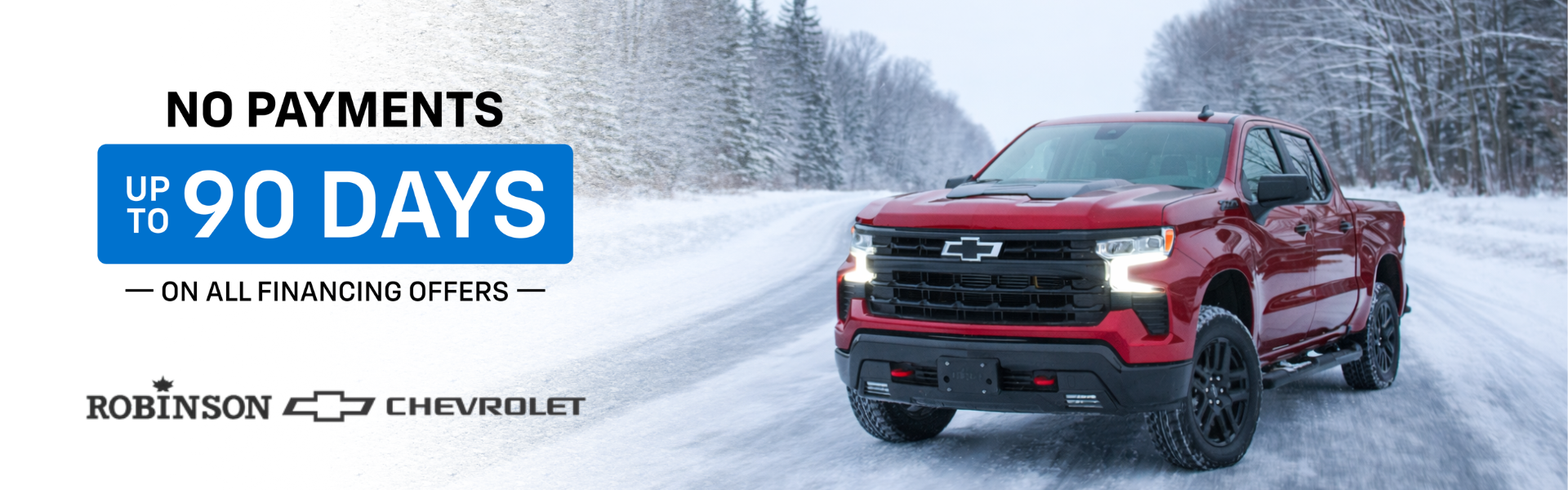 Red Chevrolet Silverado 1500 LT Trail Boss driving on a snowy Huron County road.