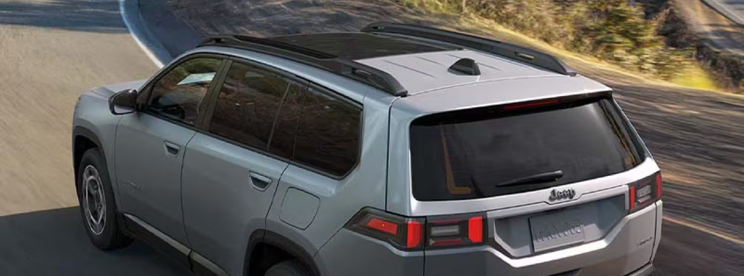 2026 Jeep Cherokee driving down a windy road