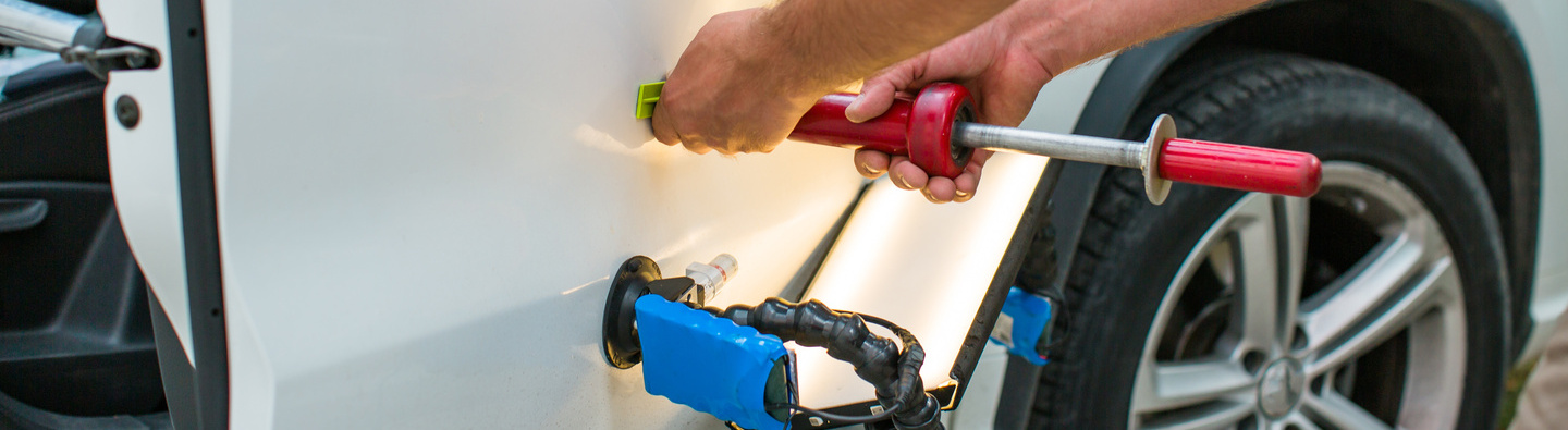 Repairing car dent after the accident by paintless dent repair