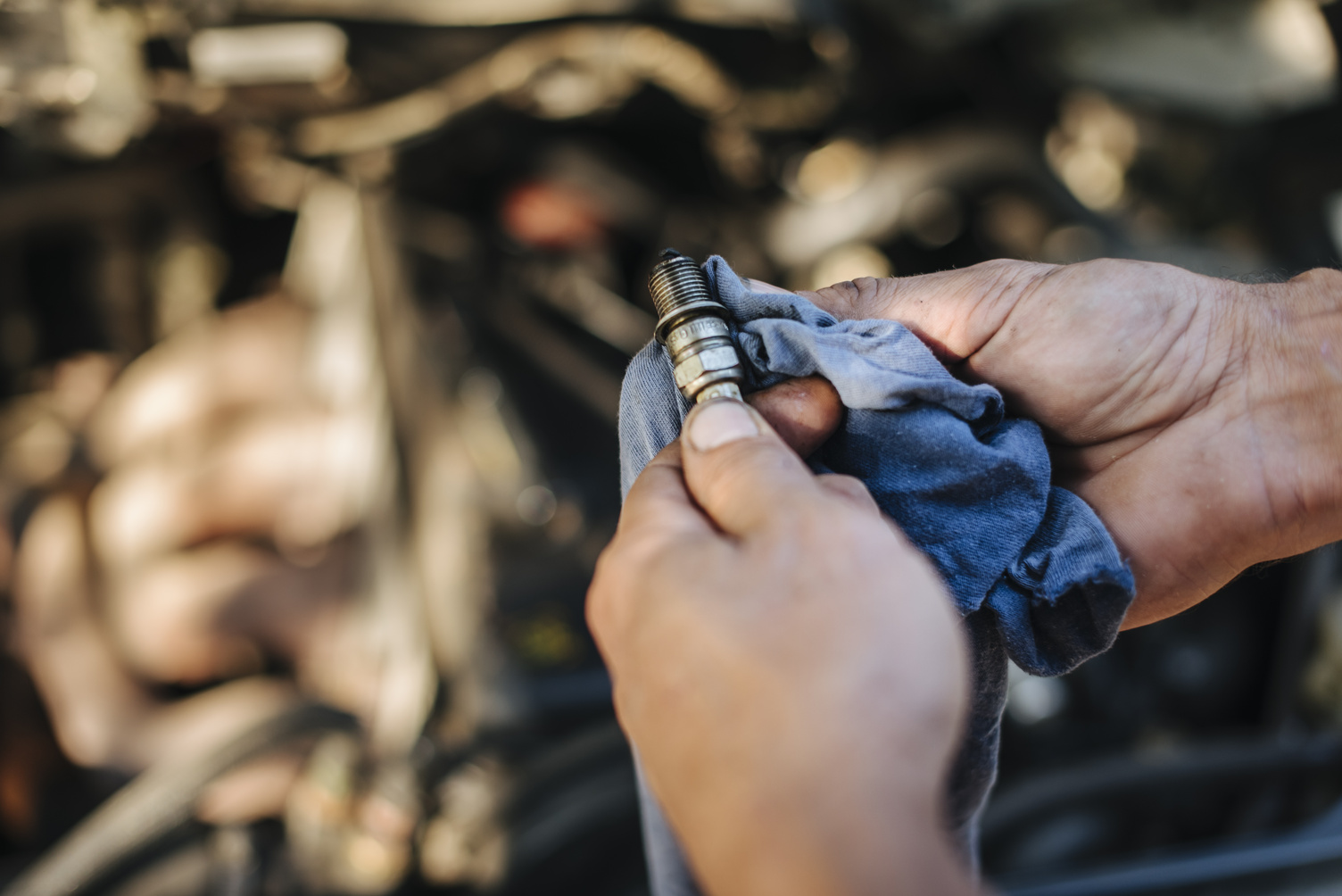 Man checks the spark plug on the old car