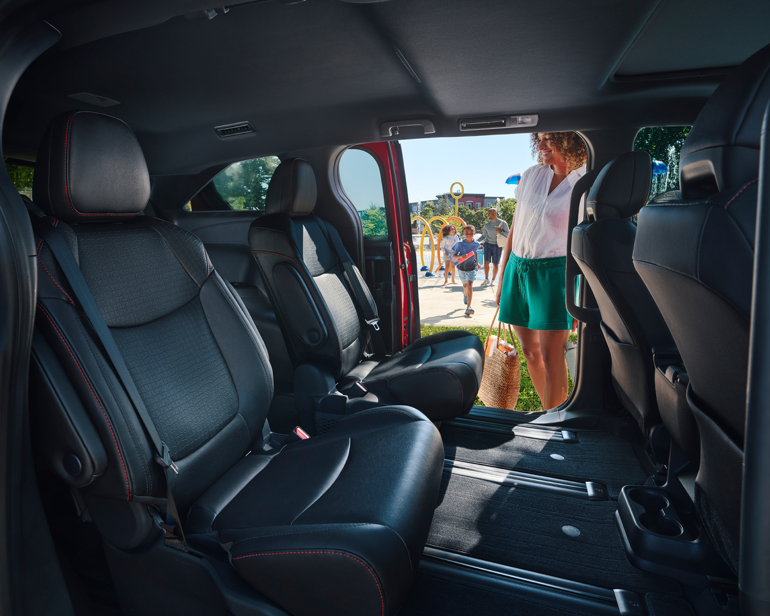 Unknown person standing with rear door of 2026 Toyota Sienna open