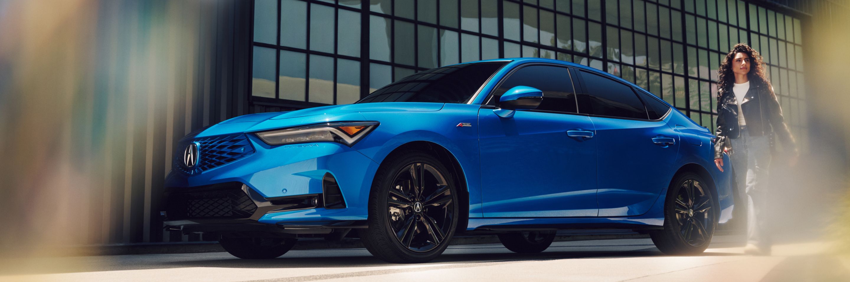 Person standing next to 2026 Acura Integra