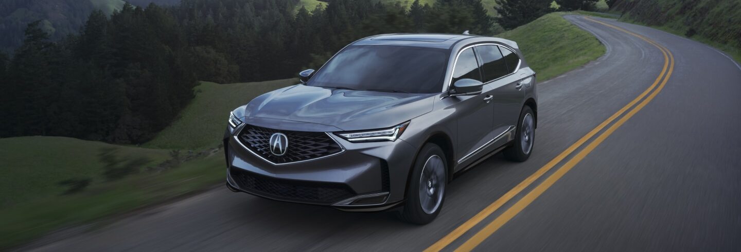 2025 Acura MDX driving down street