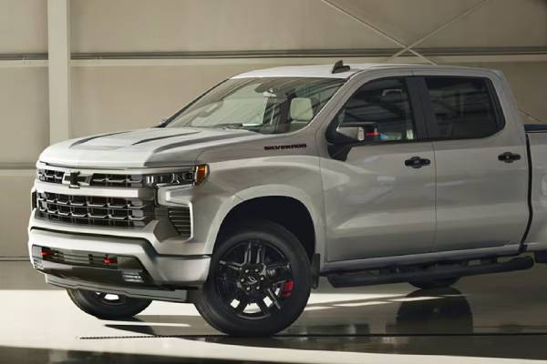 A white 2026 Chevrolet Silverado 1500 is parked in a showroom
