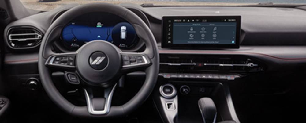 The dashboard of a 2025 Dodge Hornet showing its wheel and touchscreen. New 2025 Dodge Hornet technology features at Tarrabain Motor Products in Lac La Biche, AB