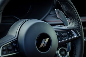 The performance steering wheel of a 2025 Dodge Hornet. 2025 Dodge Hornet Performance Specs at Tarrabain Motor Products in Lac La Biche, AB