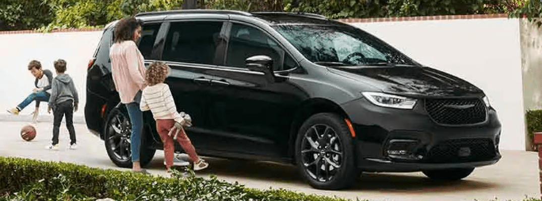 2026 Pacifica parked in the drive way with a mother and child