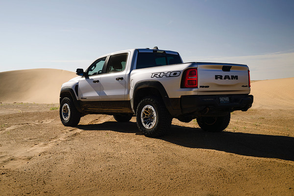 Exterior from the back of a white 2025 Ram 1500 on sand.