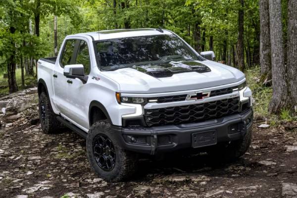 A white 2026 Chevrolet Silverado 1500 in the forest. Ram 1500 vs Chevrolet Silverado vehicle comparison at Tilbury Chrysler in Tilbury, ON