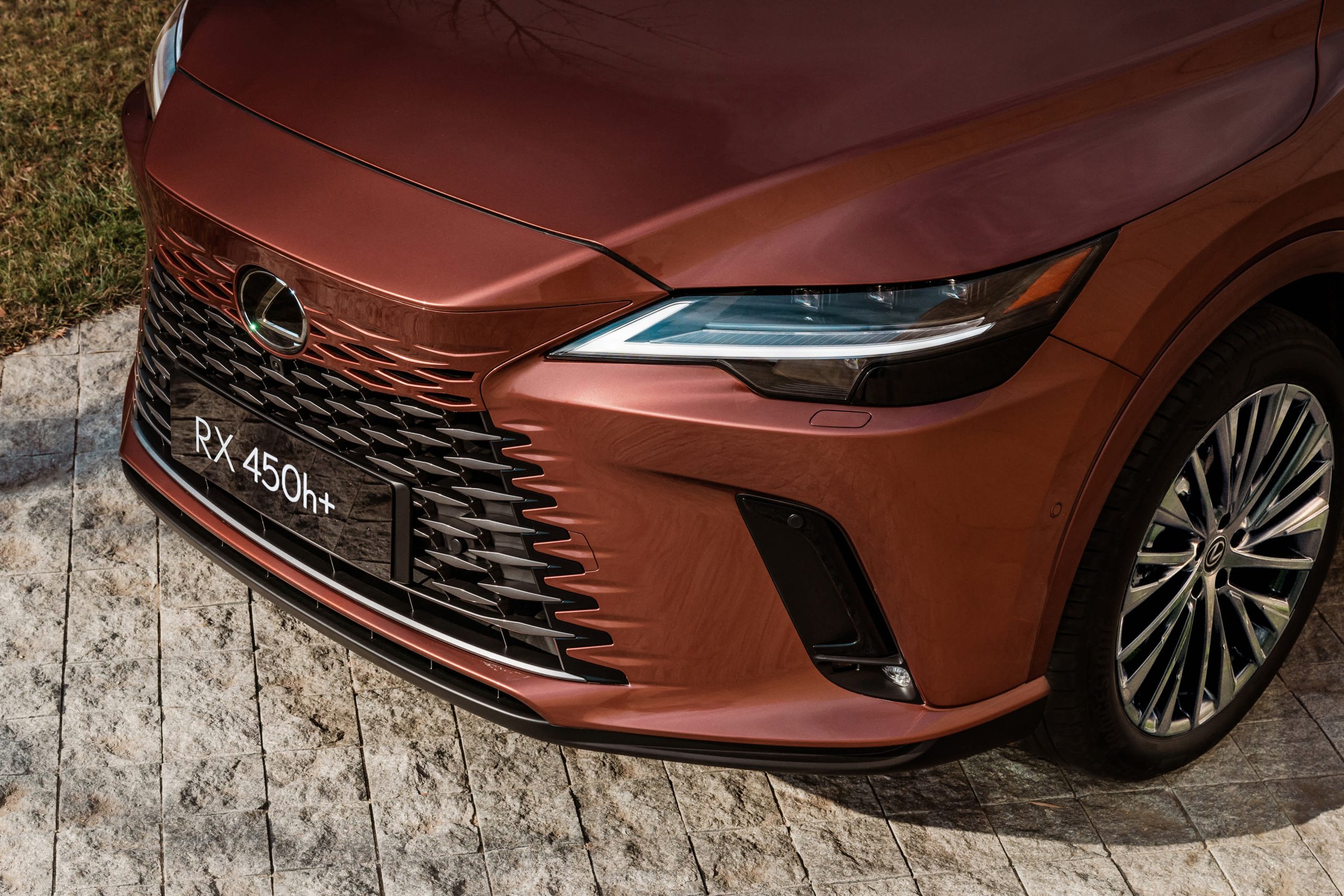 A rear view of the 2026 Lexus RX 450h in deep blue, highlighting its sculpted lines, LED light bar, and refined aerodynamic styling. Available at Tony Graham Lexus in Ottawa, the RX delivers a perfect balance of performance and luxury in gas, hybrid, and plug-in hybrid options.