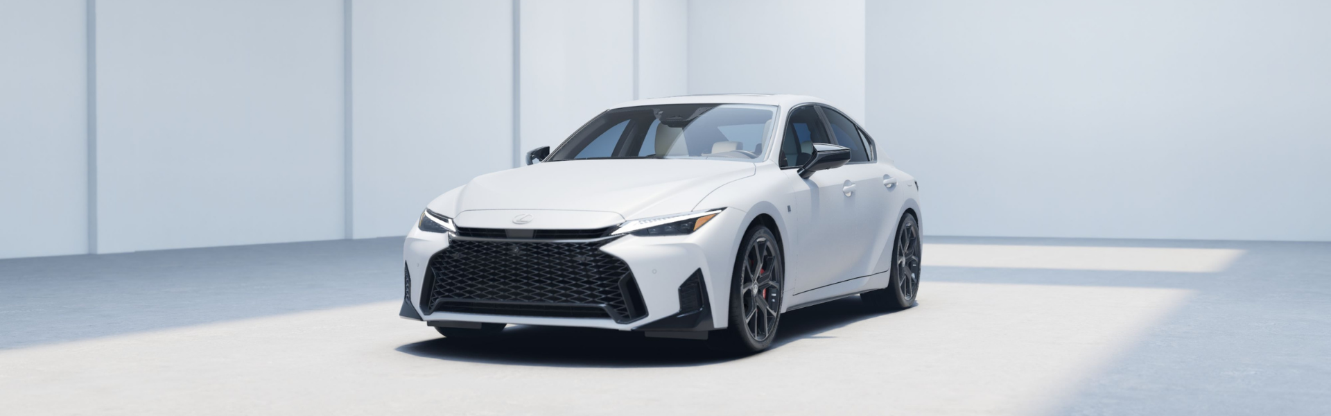 2026 Lexus IS F SPORT in white shown from front three quarter angle in studio setting
