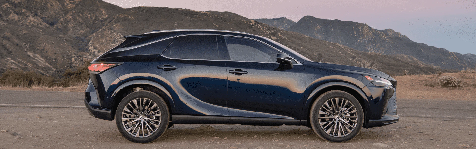 Blue 2026 Lexus RX 350h side profile parked with mountains in background