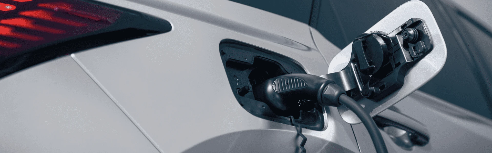 Close-up of charging port on 2026 Lexus RX 450h with plug inserted