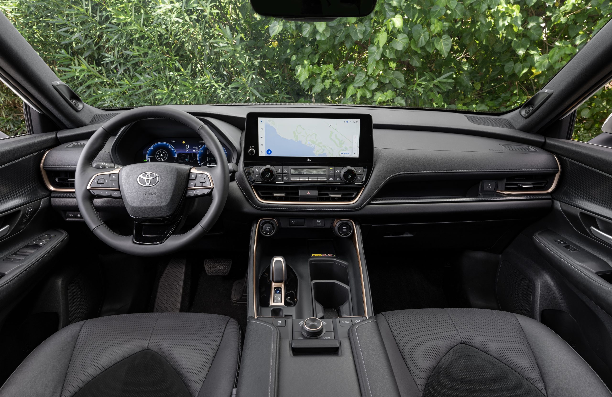 2026 Toyota Grand Highlander interior with leather seats, digital display, and 12.3-inch Toyota Multimedia touchscreen.